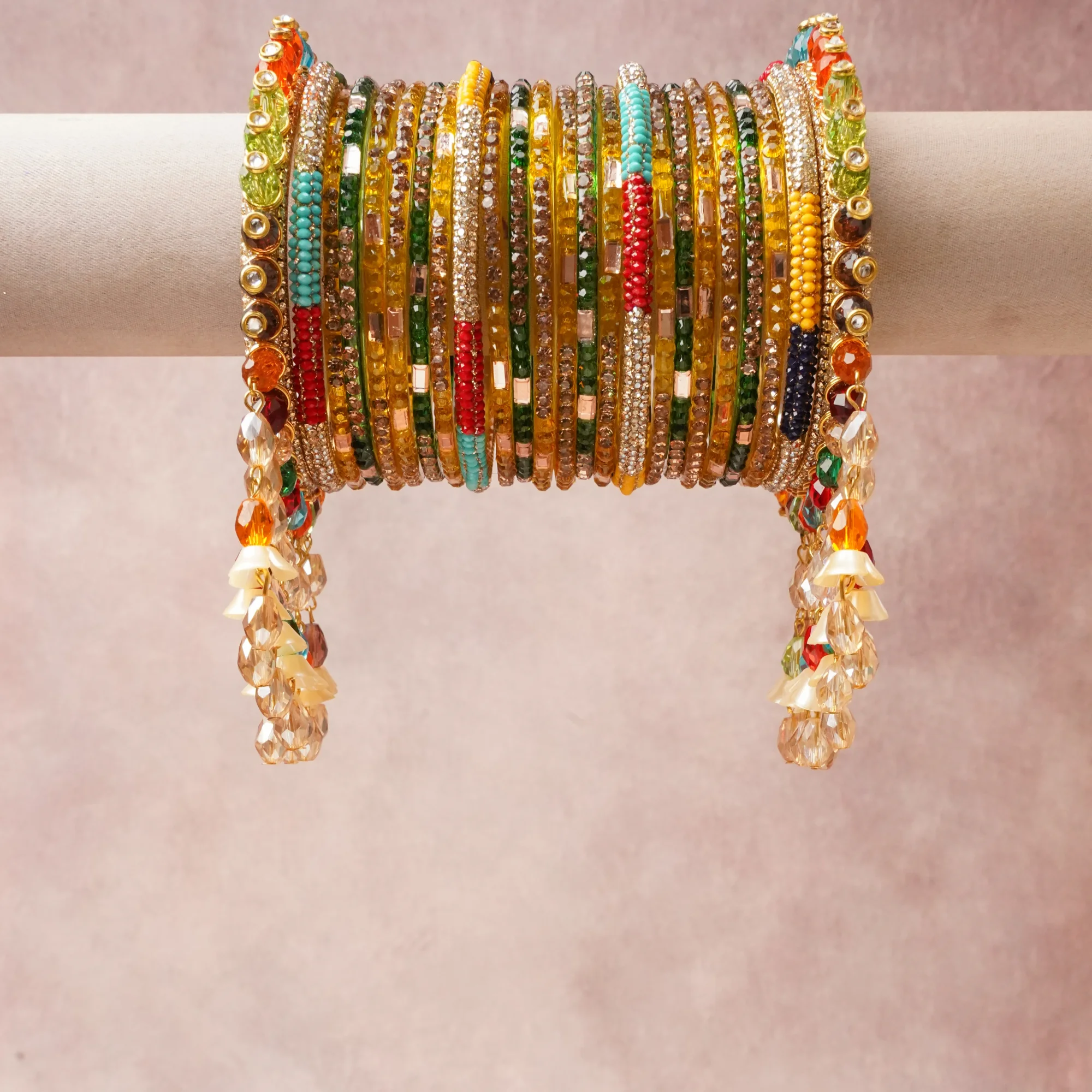 A commanding Multi colour anchors this beautiful set, enriched with accents of Emerald Green, Fuchsia Pink, Navy Blue, Teal, Ruby Red, Orange, Clear, White, Amber that add depth and dimension.

Featuring a striking composition of Gold-toned metal (alloy), Glass (bangles, beads), Rhinestones, Enamel, Faceted Glass Crystals, Faux Pearls, this set carries intricate craftsmanship and strong presence. Grand in form, it is created for moments that deserve to be marked.